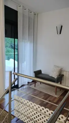 a living room with a bed and a couch at Large house surrounded by nature in Vilanova de la Roca