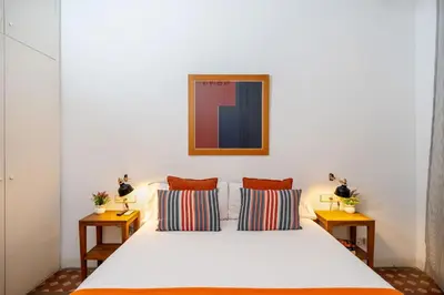 a bedroom with a white bed with two pillows at Luxury Business Apartment Gran Vía - 2 rooms - Romantic Eixample - 8min Passeig Gràcia in Barcelona