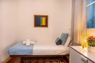 a small bedroom with a bed and a window at Luxury Business Apartment Gran Vía - 2 rooms - Romantic Eixample - 8min Passeig Gràcia in Barcelona