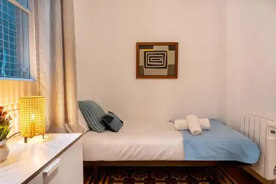 a bedroom with a bed and a table and a window at Luxury Business Apartment Gran Vía - 2 rooms - Romantic Eixample - 8min Passeig Gràcia in Barcelona
