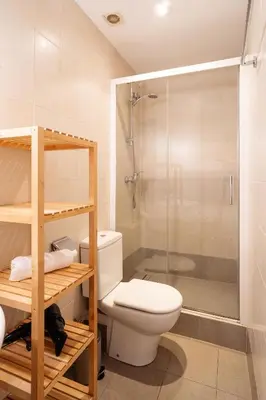 a bathroom with a toilet and a glass shower at Luxury Business Apartment Gran Vía - 2 rooms - Romantic Eixample - 8min Passeig Gràcia in Barcelona