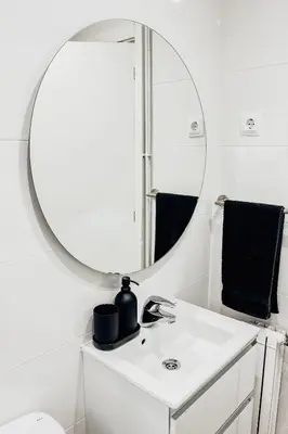 a bathroom with a mirror above a white sink at Casa Blanca in Dosríus