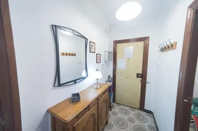 a bathroom with a mirror and a wooden dresser at Comodo y luminoso en Cornella -Barcelona- in Cornellà de Llobregat