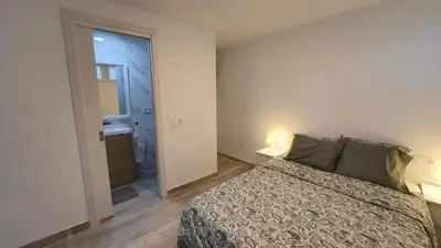 a bedroom with a bed and a door to a bathroom at Vallgorguina Uno in Vallgorguina