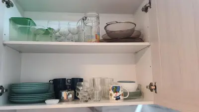 a cupboard filled with plates and glasses and dishes at Vallgorguina Uno in Vallgorguina