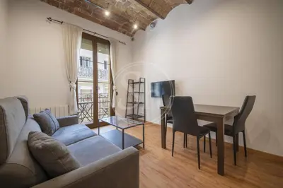 a living room with a couch and a table at Apartamento familiar en Barcelona in Barcelona