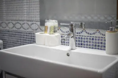 a bathroom sink with two rolls of toiletries on it at Apartamento familiar en Barcelona in Barcelona