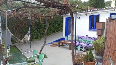 a patio with a swing and a hammock at El Portal, 12 mins from Sitges in Olivella