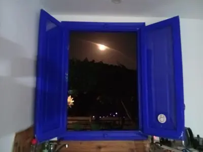 a blue window with a view of the night at El Portal, 12 mins from Sitges in Olivella