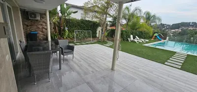a patio with a table and chairs and a swimming pool at The Family Palace in Piera