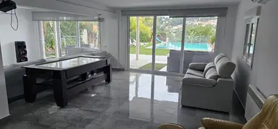 a living room with a table and a couch at The Family Palace in Piera