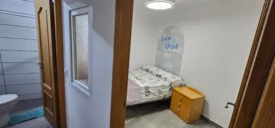 a small room with a small bed and a bathroom at The Family Palace in Piera