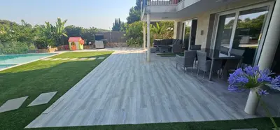 a house with a patio and a swimming pool at The Family Palace in Piera