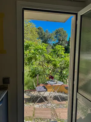 a sliding glass door with a view of a yard at Refugio verde con encanto in Vallirana