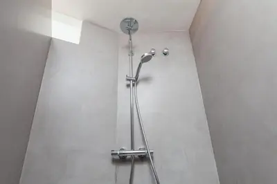 a shower stall with a fan in a bathroom at Lodging Apartments Beach Apartment Villa Olimpica in Barcelona