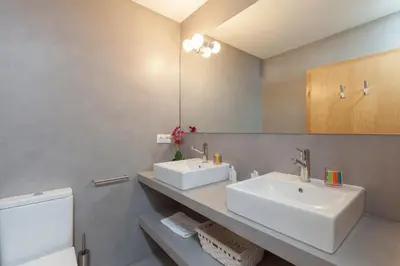 a bathroom with two sinks and a mirror at Lodging Apartments Beach Apartment Villa Olimpica in Barcelona