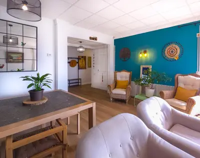 a living room with blue walls and white furniture at Mikasi Hills by Hello Homes Sitges in Sant Pere de Ribes