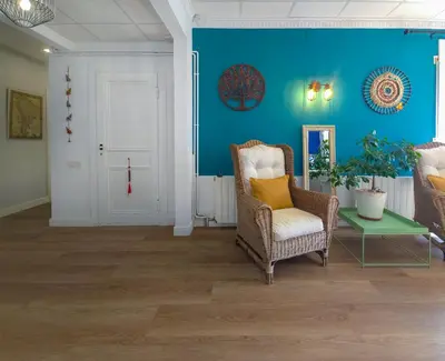 a living room with a chair and a table at Mikasi Hills by Hello Homes Sitges in Sant Pere de Ribes