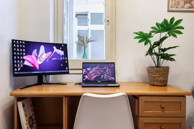 a desk with a computer and a laptop on it at Apartamento Moderno con Balcón Meridiana Barcelona in Barcelona