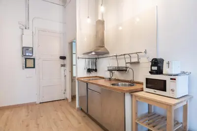 a kitchen with a sink and a microwave at Charm and Comfort in the Heart of Sant Antoni, Barcelona in Barcelona