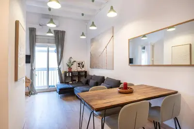 a living room with a table and a couch at Charm and Comfort in the Heart of Sant Antoni, Barcelona in Barcelona