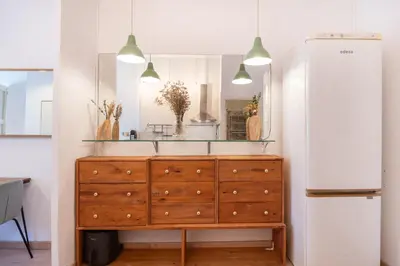 a dresser with a mirror on top of it at Charm and Comfort in the Heart of Sant Antoni, Barcelona in Barcelona