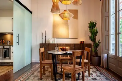 a desk with a laptop and a potted plant next to a window at Zagora - 2 bedrooms in Eixample Dreta in Barcelona