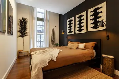 a bedroom with a large bed with paintings on the wall at Zagora - 2 bedrooms in Eixample Dreta in Barcelona