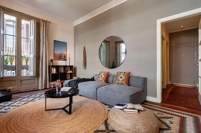 a living room with a couch and a book shelf at Zagora - 2 bedrooms in Eixample Dreta in Barcelona