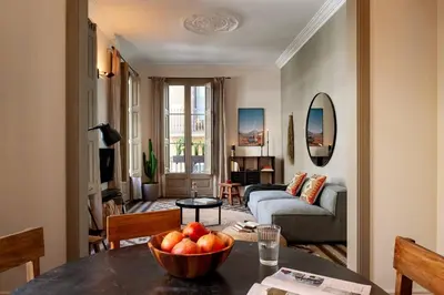 a living room with a couch and a table at Zagora - 2 bedrooms in Eixample Dreta in Barcelona