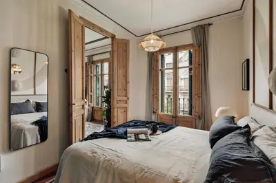 a bedroom with a bed with a table on it at Lura - 2 bedrooms and terrace in Eixample Esquerra in Barcelona