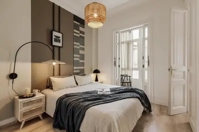a bedroom with a large bed and a walk in shower at Quira - 4 bedrooms and balcony in Eixample Dreta in Barcelona