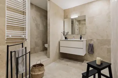 a bedroom with a bed and a chair at Quira - 4 bedrooms and balcony in Eixample Dreta in Barcelona