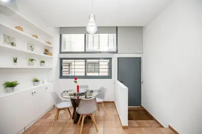 a kitchen and dining room with a table and chairs at Urban Gracia in Barcelona