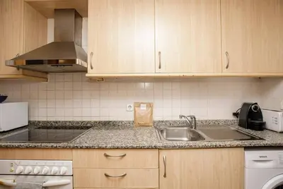 a kitchen with a sink and a stove at Urban Gracia in Barcelona