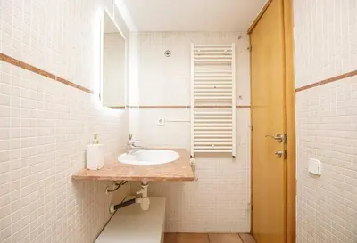 a white bathroom with a sink and a mirror at Urban Gracia in Barcelona