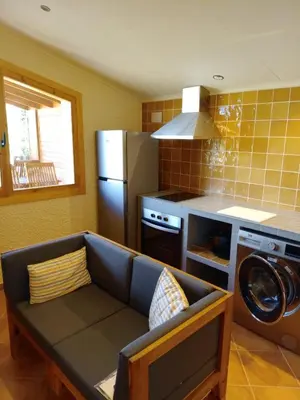 a living room with a couch in a kitchen at Apartament rural in San Martín Sarroca