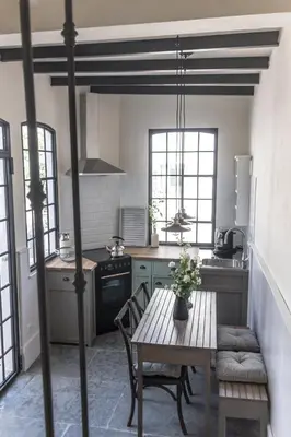 a kitchen with a table and a stove and a sink at Traumhäuschen am Meer für 2, Barcelona in Vilassar de Mar