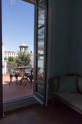 a door to a balcony with a table and chairs at Traumhäuschen am Meer für 2, Barcelona in Vilassar de Mar