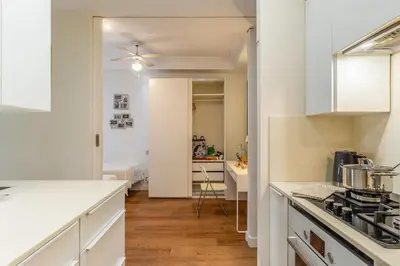 a kitchen with white cabinets and a counter top at Canela Homes BARCELONA GLÒRIES in Barcelona