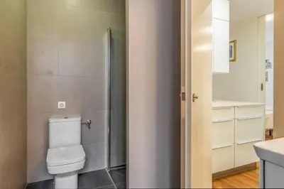 a bathroom with a toilet and a sink at Canela Homes BARCELONA GLÒRIES in Barcelona