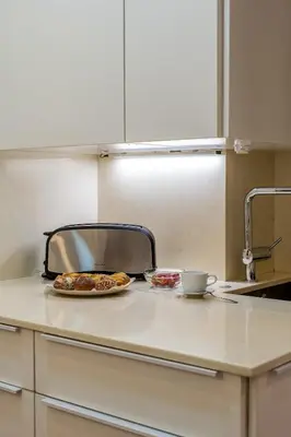 a kitchen counter with a plate of food and a toaster at Canela Homes BARCELONA GLÒRIES in Barcelona