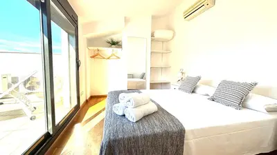 a bedroom with a large bed with towels on it at Dúplex zona olimpica by Prestigi in Terrassa