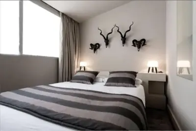 a bedroom with a bed with antlers on the wall at Stay Unique Apartment Minerva in Barcelona