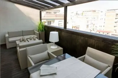 a balcony with chairs and tables and a large window at Stay Unique Apartment Minerva in Barcelona
