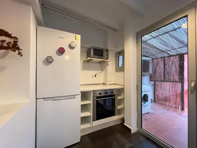 a kitchen with a refrigerator and a microwave at Stay Unique Apartment Martínez de la Rosa in Barcelona