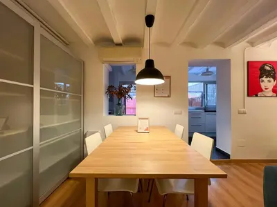 a dining room with a wooden table and chairs at Stay Unique Apartment Martínez de la Rosa in Barcelona