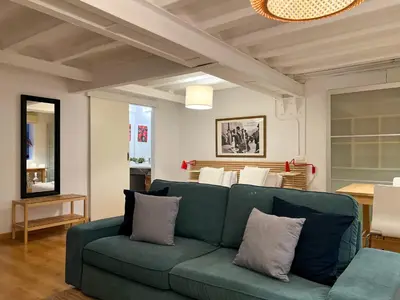 a living room with a blue couch and a table at Stay Unique Apartment Martínez de la Rosa in Barcelona