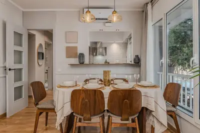 a dining room with a table and chairs at NEW Refurbished Modern Apartment in Barcelona