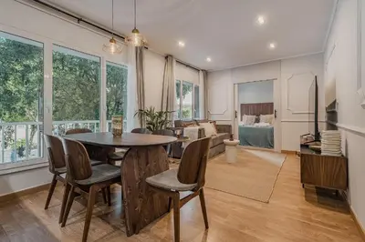 a dining room and living room with a table and chairs at NEW Refurbished Modern Apartment in Barcelona